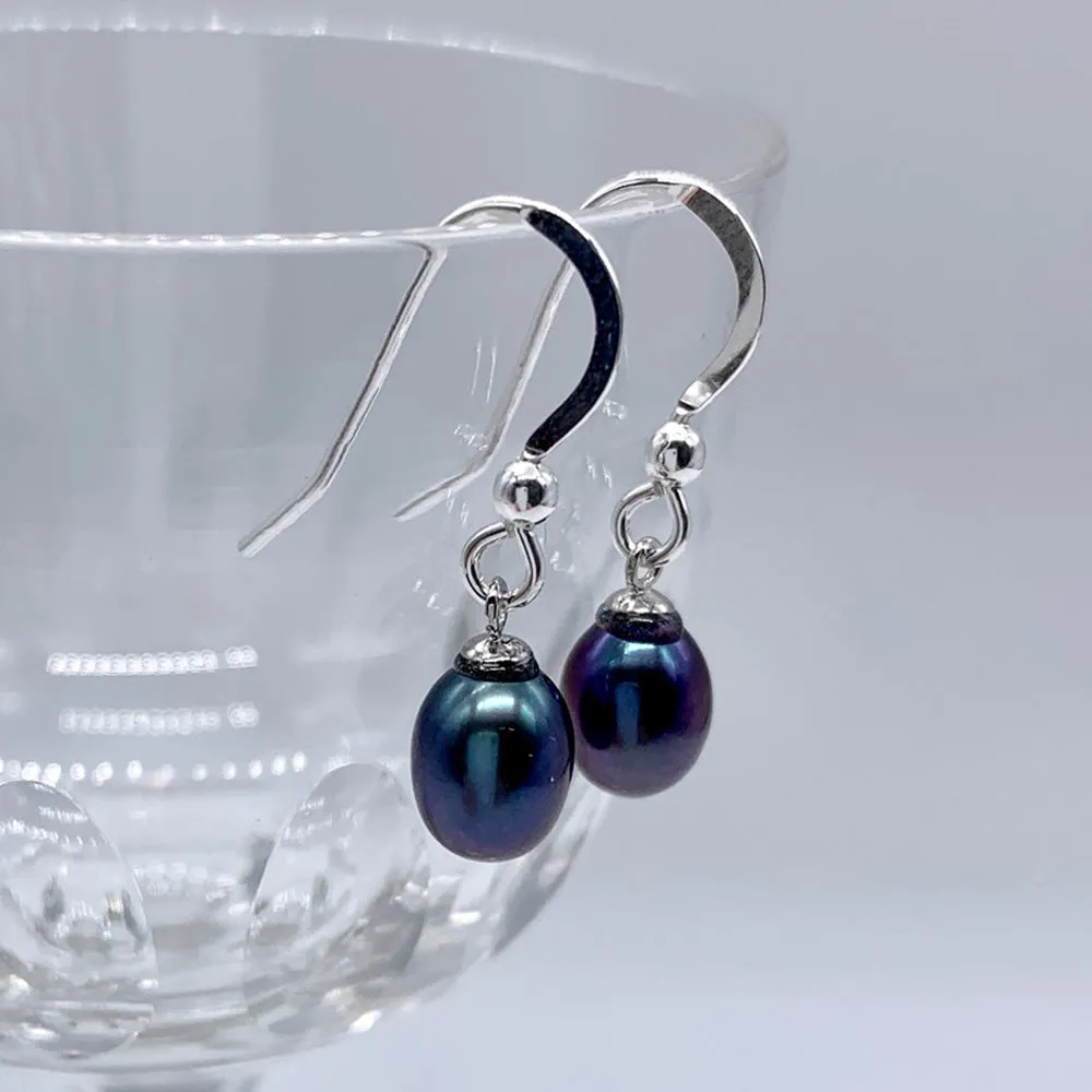 Pearl earrings with small freshwater natural black oval pearl drops on silver hooks